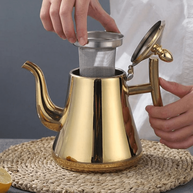 Gold teapot with a tea strainer