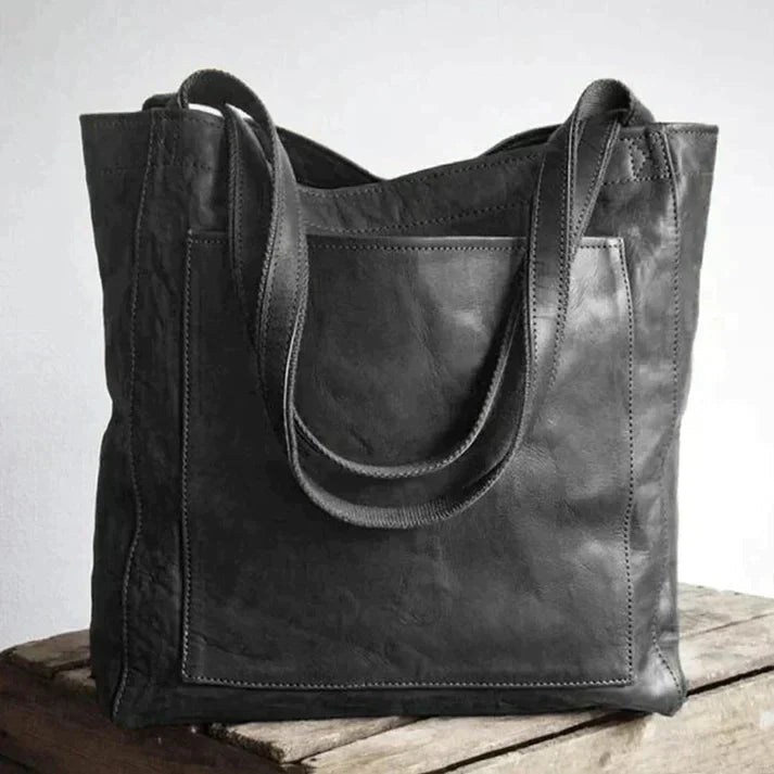Elegant black shoulder bag made from durable PU leather with adjustable strap and organized interior compartments - Euroselle