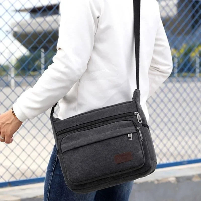 Bolso bandolera de lona — correa ajustable, bolsillos con cremallera