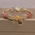 Pulsera de cuentas de labradorita y cuarzo fresa — dije de luna y estrella